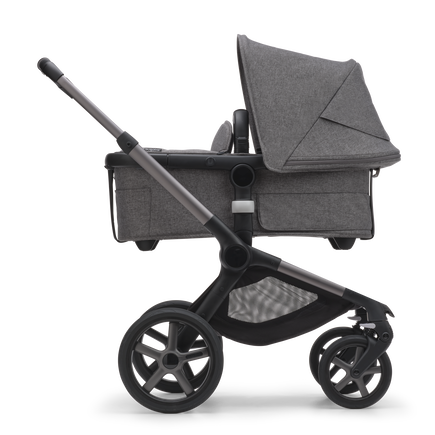 Side view of the Bugaboo Fox 5 bassinet stroller with graphite chassis, grey melange fabrics and grey melange sun canopy. - view 2