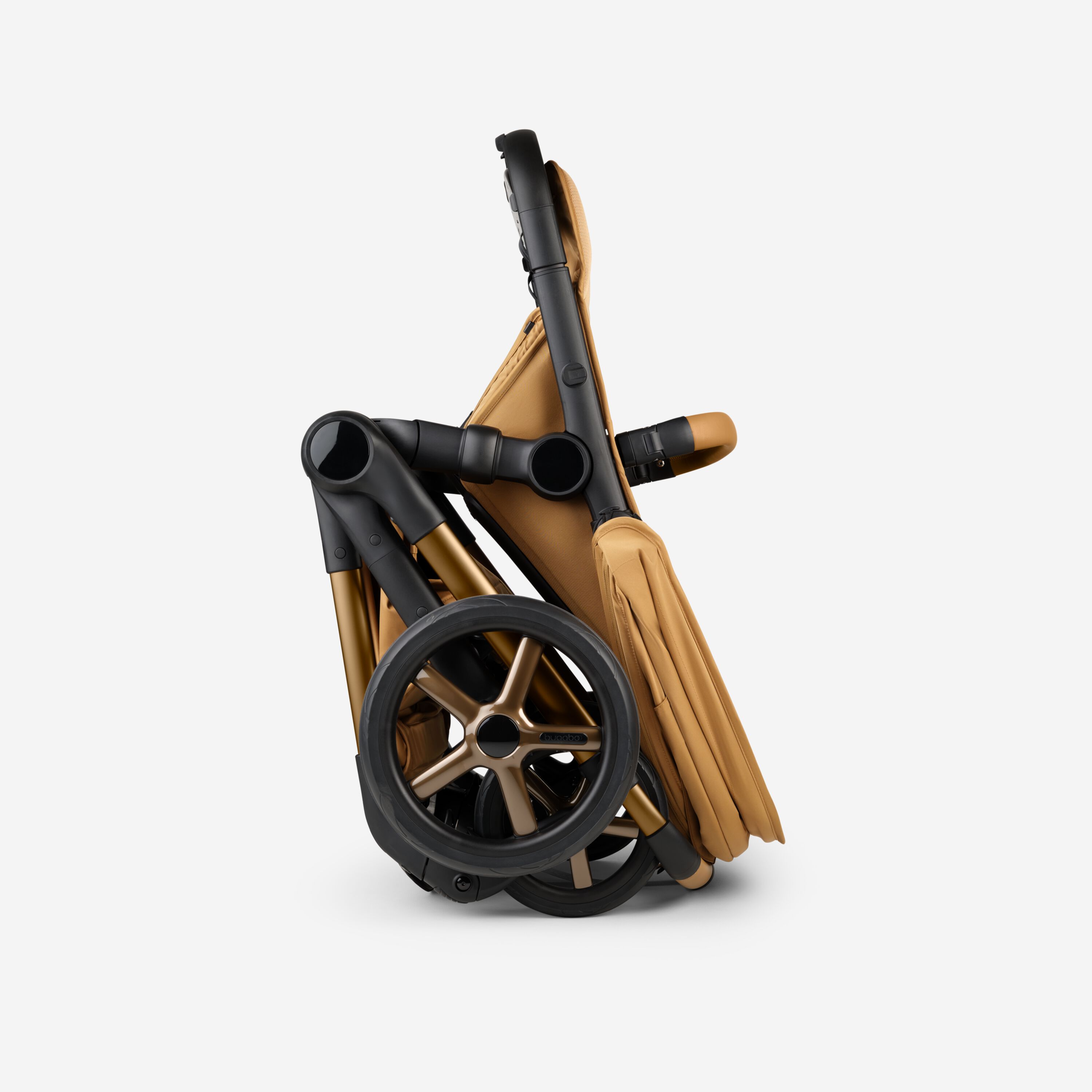 A Bugaboo Fox 5 Noir Limited Edition stroller in Amber Glow, shown in a folded position. - Main Modal Image Slide 10 of 15