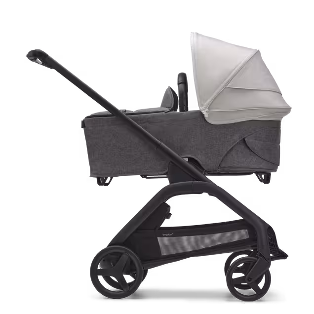 Side view of the Bugaboo Dragonfly bassinet stroller with black chassis, grey melange fabrics and misty white sun canopy. - Main Image Slide 3 of 16