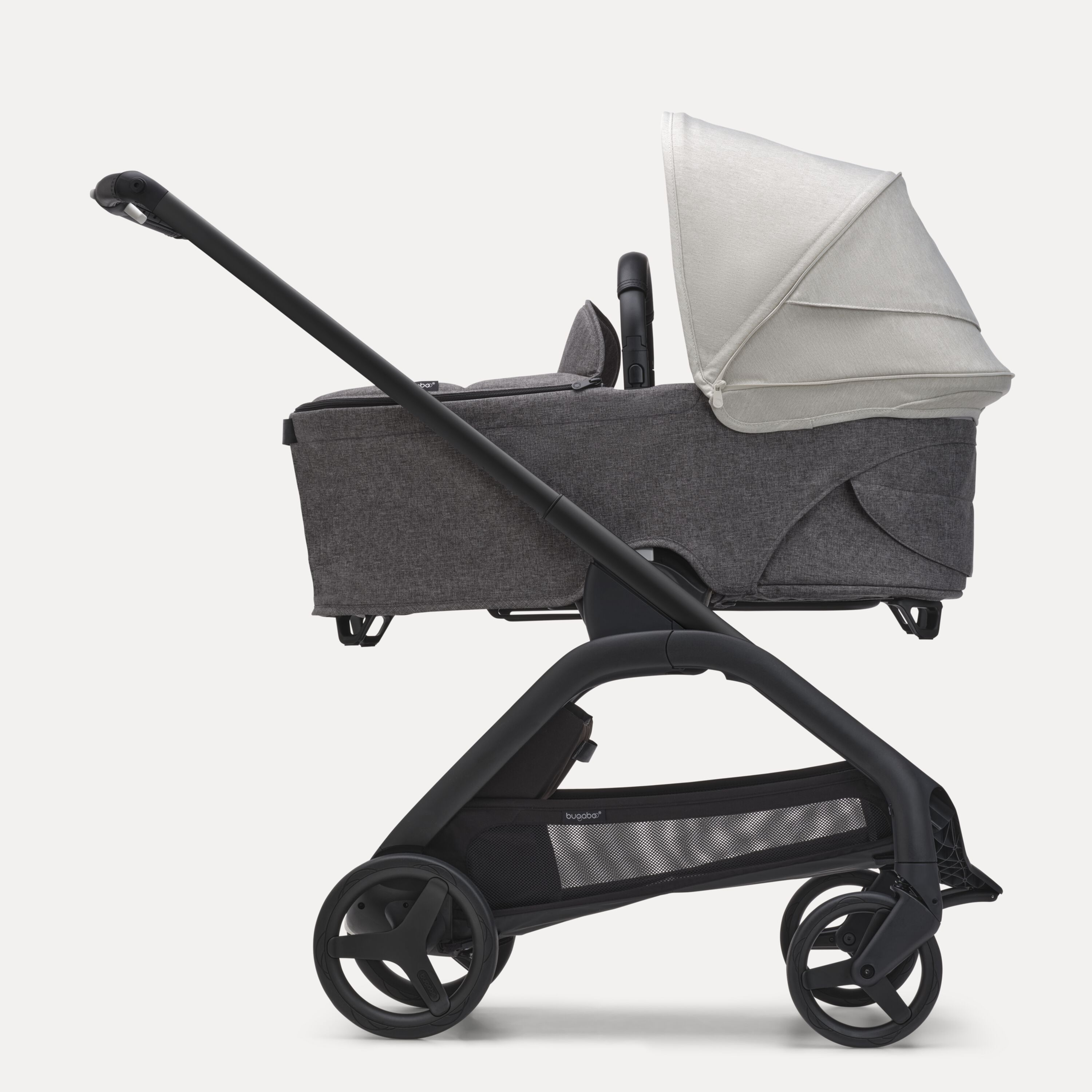 Side view of the Bugaboo Dragonfly bassinet stroller with black chassis, grey melange fabrics and misty white sun canopy. - Main Modal Image Slide 3 of 16