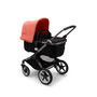 Bugaboo Fox 3 bassinet stroller with graphite frame, black fabrics, and red sun canopy.