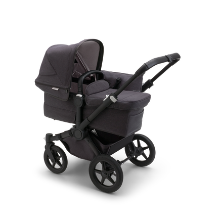 Bugaboo Donkey 5 Mono bassinet stroller with black chassis, mineral washed black fabrics and mineral washed black sun canopy.