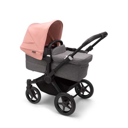 Bugaboo Donkey 5 Mono bassinet stroller with black chassis, grey melange fabrics and morning pink sun canopy.
