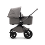 Side view of a Fox 3 bassinet stroller with graphite frame, light grey fabrics and light grey sun canopy.