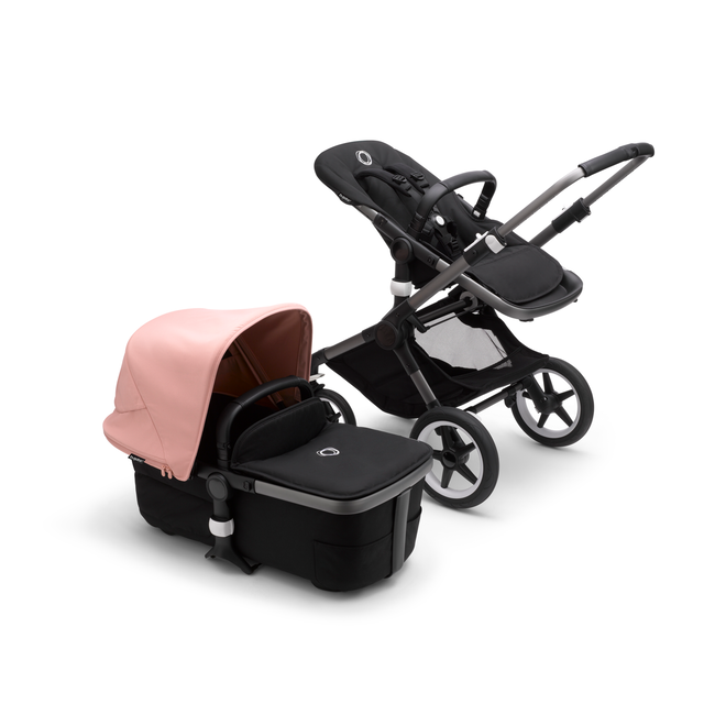 Bugaboo Fox 3 bassinet and seat stroller with graphite frame, black fabrics, and pink sun canopy.