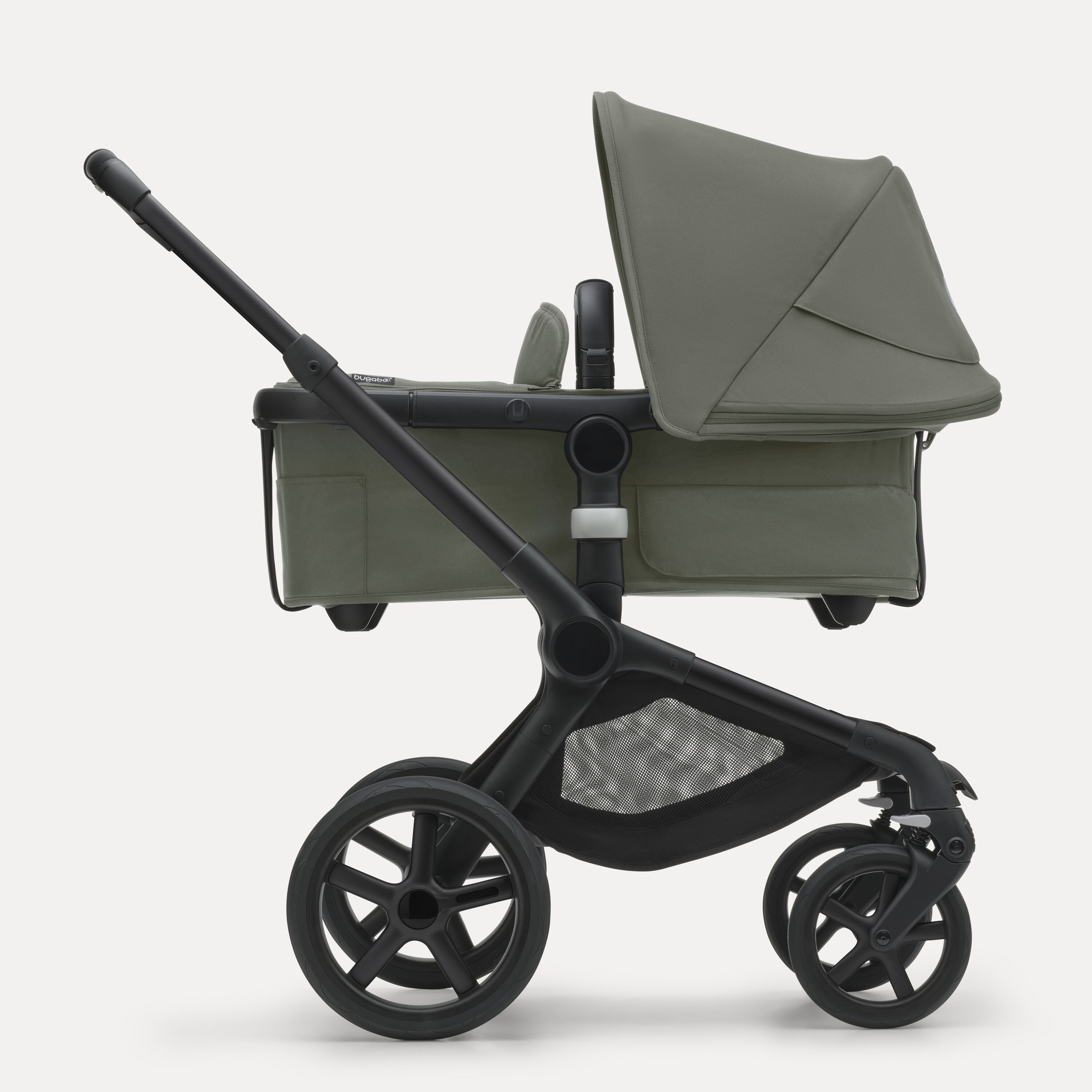 Side view of the Bugaboo Fox 5 carrycot pushchair with black chassis, forest green fabrics and forest green sun canopy. - Main Modal Image Slide 2 of 13