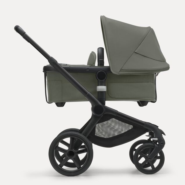 Side view of the Bugaboo Fox 5 carrycot pushchair with black chassis, forest green fabrics and forest green sun canopy. - Main Image Slide 2 of 13