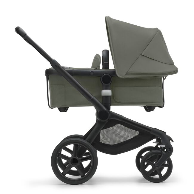 Side view of the Bugaboo Fox 5 carrycot pushchair with black chassis, forest green fabrics and forest green sun canopy. - Main Image Slide 3 of 16