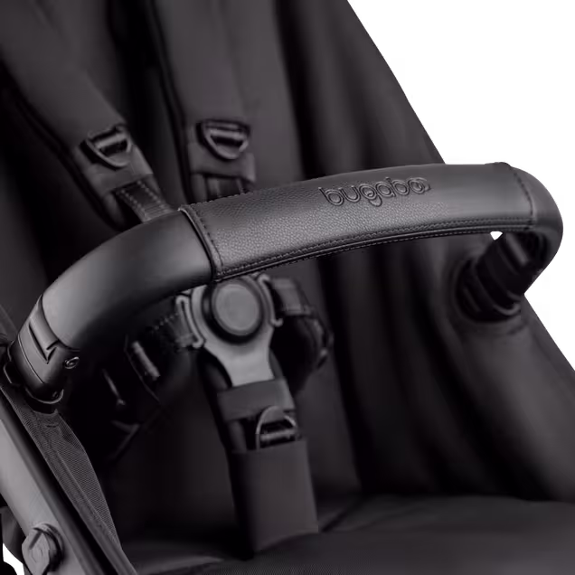 A close-up of the seat of the Bugaboo Kangaroo 2-in-1 stroller, with focus on the carry handle and the five-point safety harness. - Main Image Slide 15 of 18