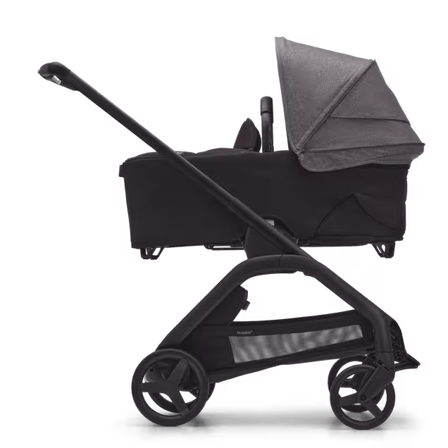 Side view of the Bugaboo Dragonfly bassinet stroller with black chassis, midnight black fabrics and grey melange sun canopy. - Main Image Slide 3 of 16