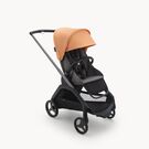 Carrito con silla Bugaboo Dragonfly con chasis grafito, fundas gris melange y capota coral isla.