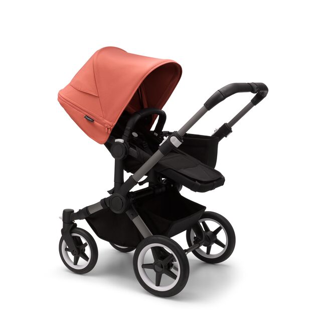 Bugaboo Donkey 5 Mono seat stroller with graphite chassis, midnight black fabrics and sunrise red sun canopy.