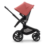 Side view of the Bugaboo Fox 5 seat stroller with black chassis, grey melange fabrics and sunrise red sun canopy. - Thumbnail Slide 4 of 15