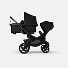 Bugaboo Kangaroo 2-in-1 tandem stroller with one bassinet above and one seat below, with Midnight Black fabrics and Midnight Black sun canopies.