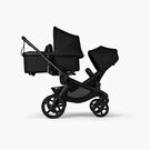Bugaboo Kangaroo 2-in-1 tandem stroller with one bassinet above and one seat below, with Midnight Black fabrics and Midnight Black sun canopies.