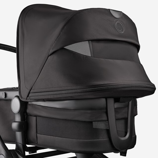 Eine Nahaufnahme des Sonnendachs und der Liegewanne des Bugaboo Fox 5 Noir Limited Edition in der Farbvariante Tiefschwarz. Das Sonnendach und die Lüftungseinsätze der Liegewanne sind sichtbar. - Main Image Slide 7 of 15