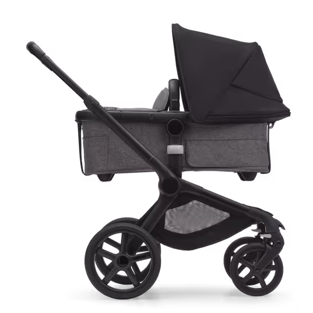Side view of the Bugaboo Fox 5 bassinet stroller with black chassis, grey melange fabrics and midnight black sun canopy. - Main Image Slide 2 of 13