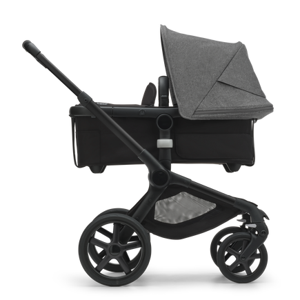 Side view of the Bugaboo Fox 5 bassinet pram with black chassis, forest green fabrics and forest green sun canopy. - view 2