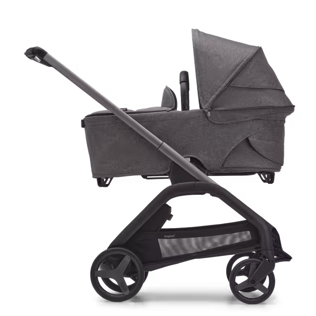 Side view of the Bugaboo Dragonfly carrycot pushchair with graphite chassis, grey melange fabrics and grey melange sun canopy. - Main Image Slide 3 of 16