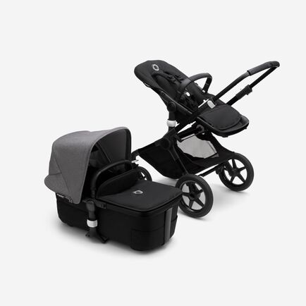 Bugaboo Fox 3 bassinet and seat stroller with black frame, black fabrics, and grey sun canopy.