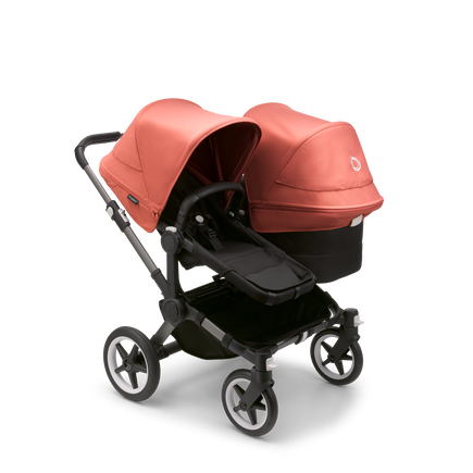 Bugaboo Donkey 5 Duo seat and bassinet stroller with graphite chassis, midnight black fabrics and sunrise red sun canopy. - view 1