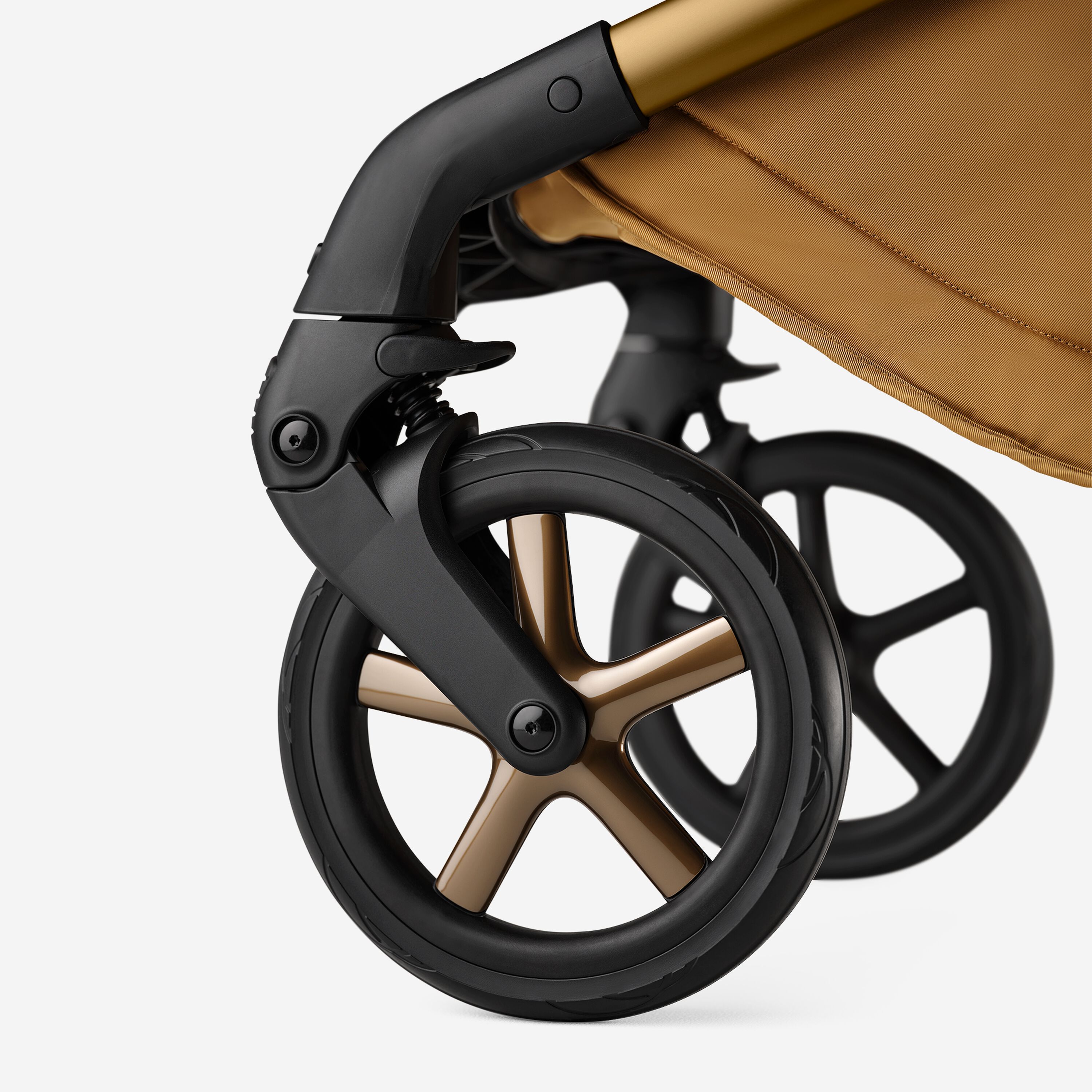 A close up of the wheels of the Bugaboo Fox 5 Noir Limited Edition Amber Glow. The wheel caps have polished rims. - Main Modal Image Slide 12 of 15