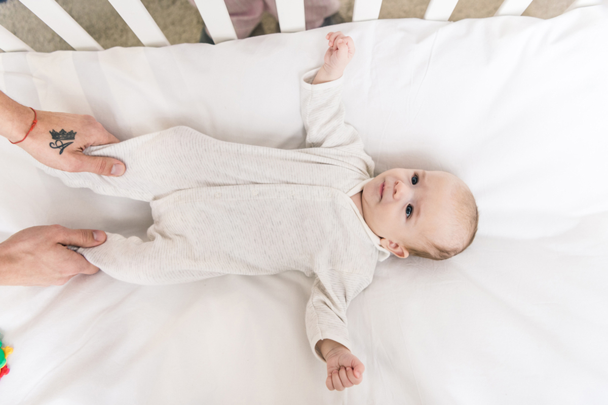 Infant in crib, a baby must-have item