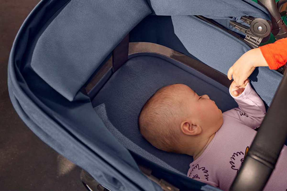 Baby sleeping in a bassinet stroller