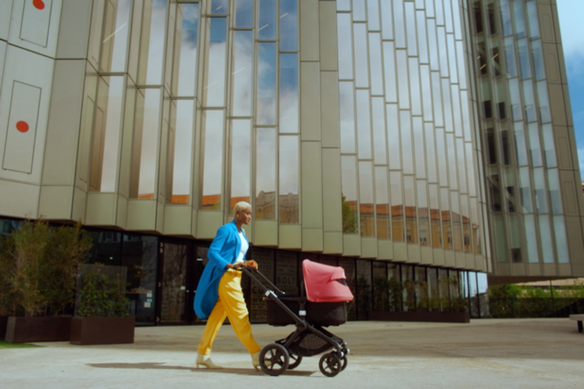 Mother walking with a stroller during the fourth trimester