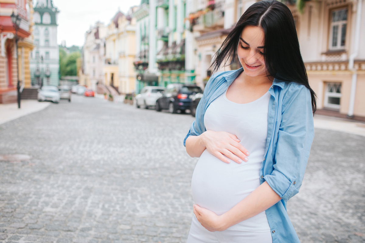Pregnant woman exploring a new city during her second trimester