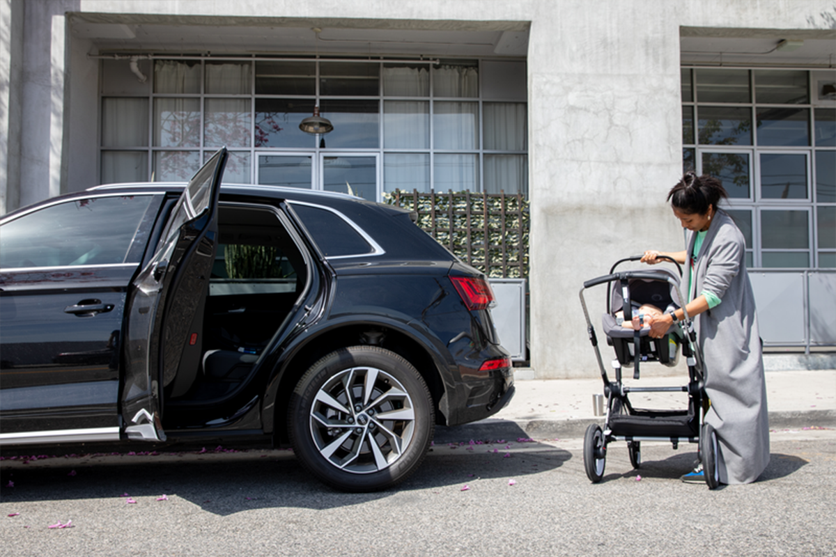 Woman putting car seat in car