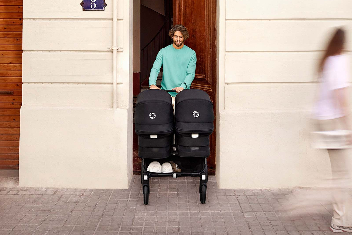 Man walking with a twin stroller