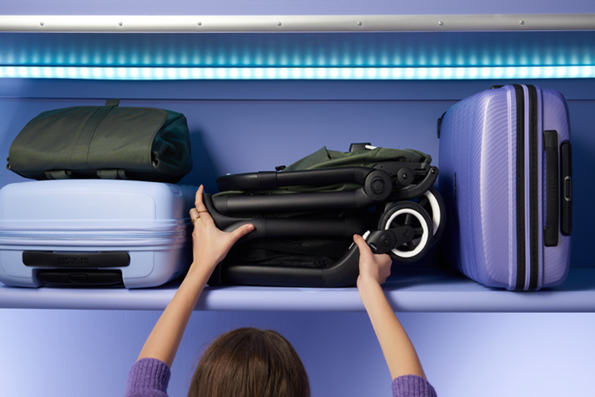 Bugaboo travel stroller being stored overhead on an airplane