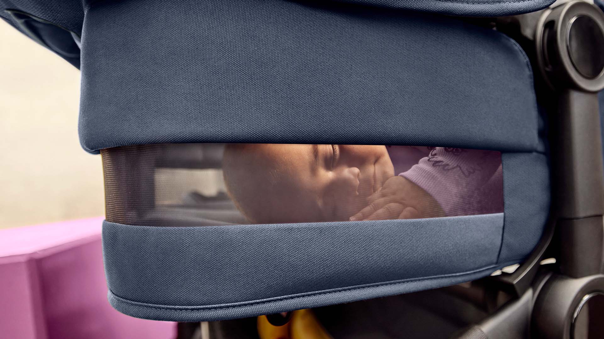 Baby sleeping peacefully inside a Bugaboo breezy bassinet