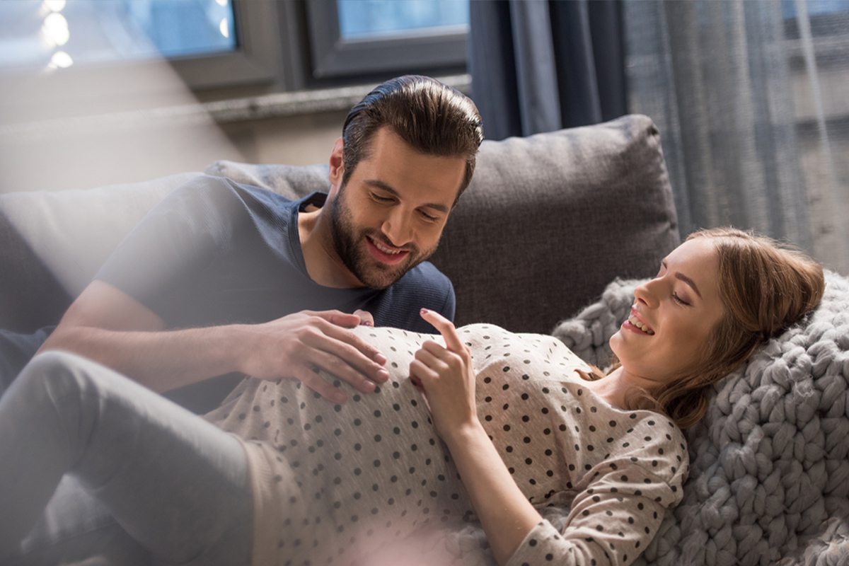 Couple feeling baby kick in the third trimester