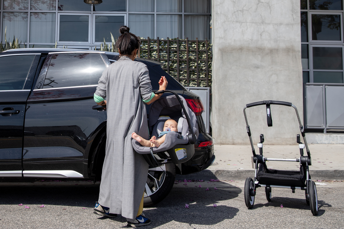 Mom putting baby into car