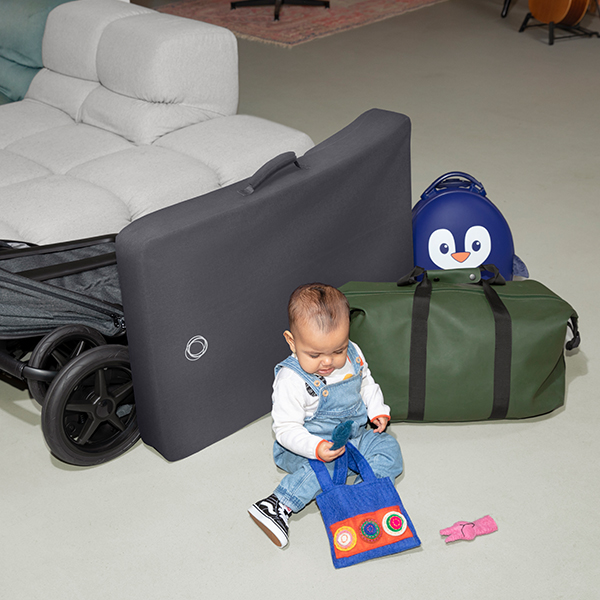 Baby playing in front of a Bugaboo portable play yard