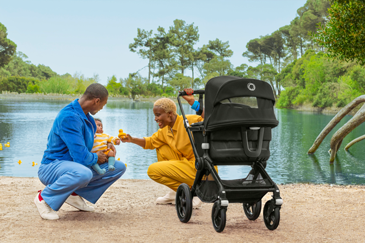 A family with a baby enjoying an adventure to a pond