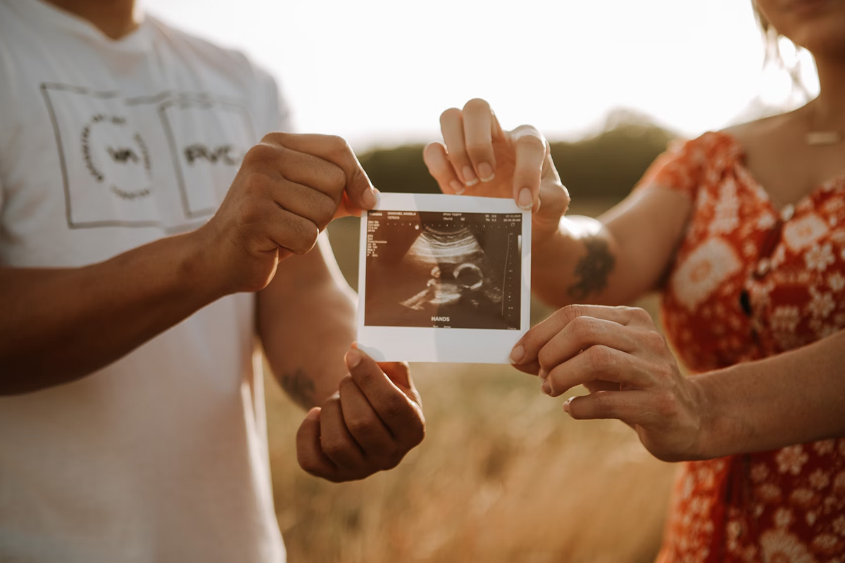 Expecting couple with photo of baby’s ultrasound