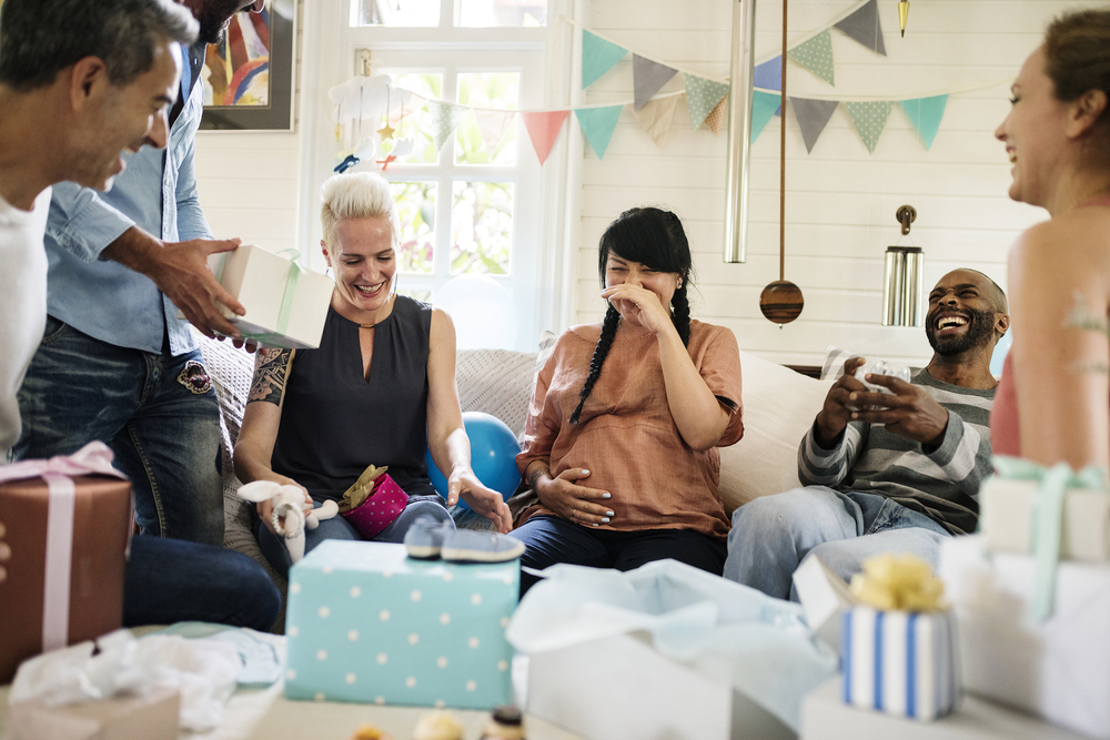 A group of people enjoying a colorful baby shower theme