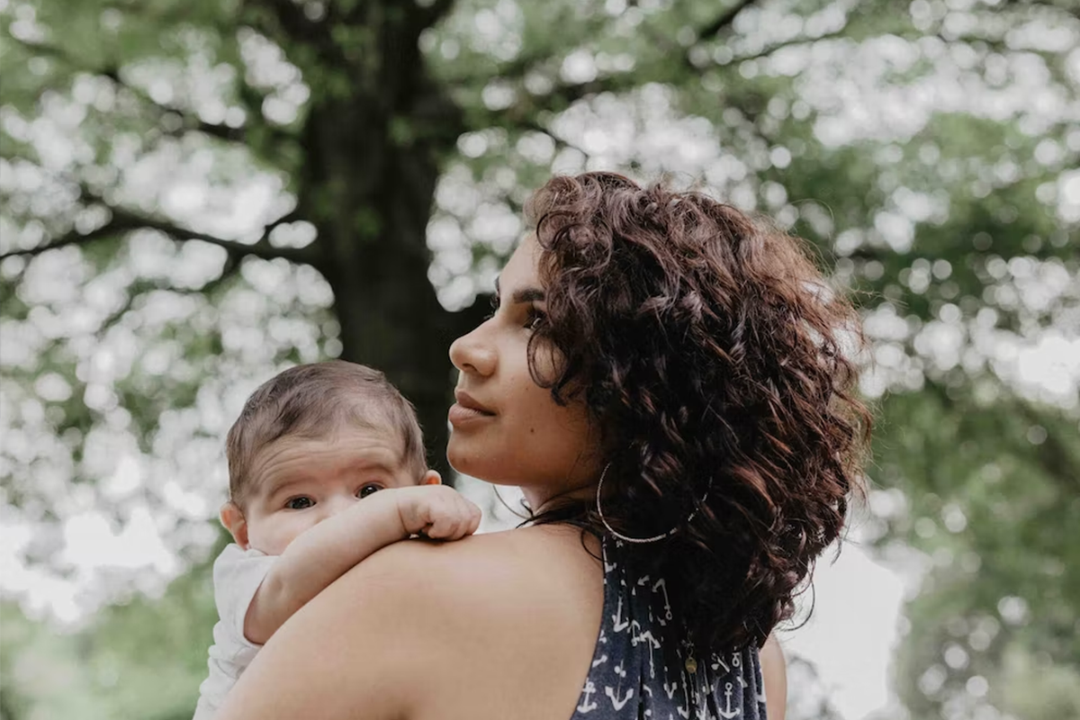 Mother holding new baby during the fourth trimester