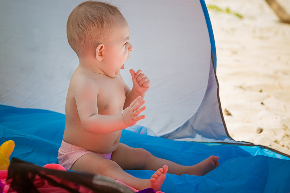 Baby in beach tent